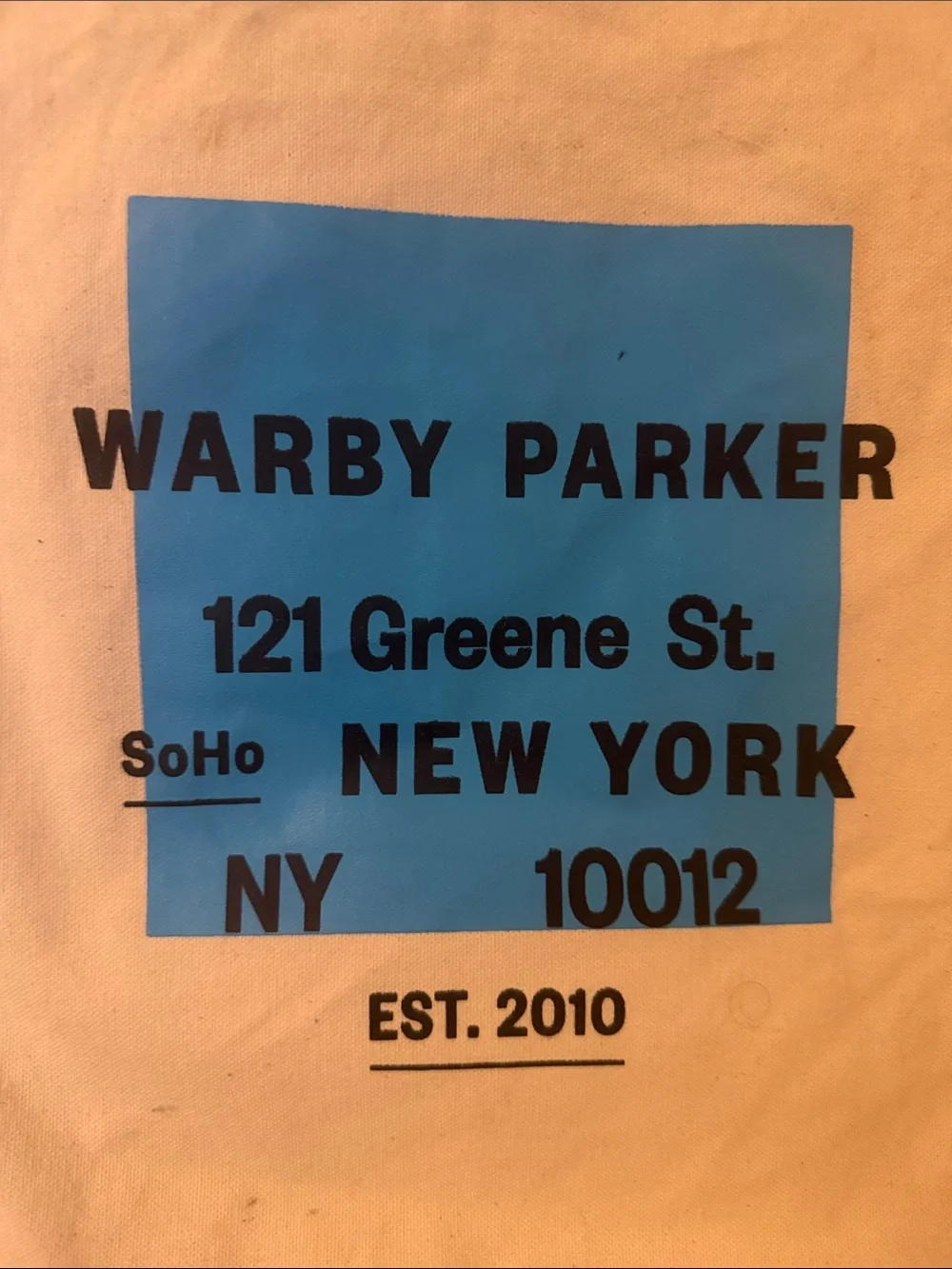Warby Parker Cream Canvas Tote with Bright Blue Graphic